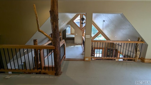 additional living space featuring ceiling fan and vaulted ceiling