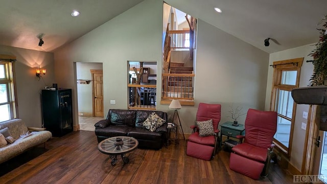 living room with lofted ceiling and dark hardwood / wood-style floors