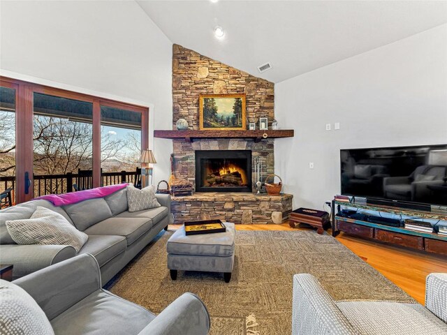 130 Cross Vine Dr, Tuckasegee, NC 28783 - living room with high vaulted ceiling, a fireplace, wood finished floors, and visible vents