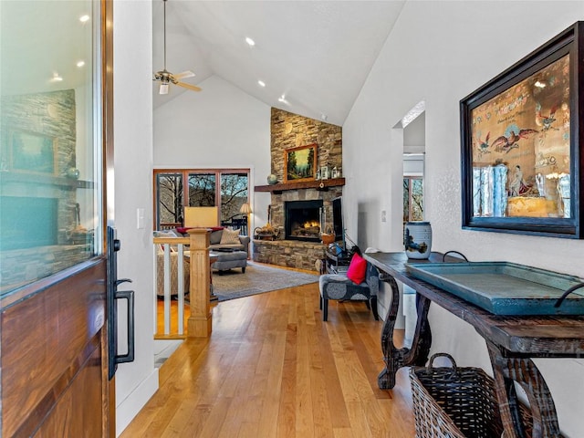 130 Cross Vine Dr, Tuckasegee, NC 28783 - interior space with high vaulted ceiling, a stone fireplace, light wood-style flooring, and a ceiling fan