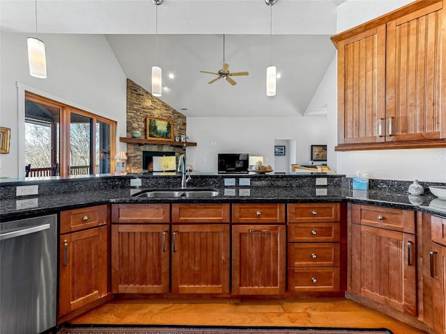 130 Cross Vine Dr, Tuckasegee, NC 28783 - kitchen with stainless steel dishwasher, light wood-style floors, brown cabinetry, a sink, and dark stone countertops