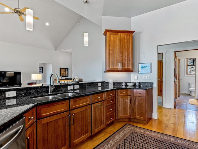 130 Cross Vine Dr, Tuckasegee, NC 28783 - kitchen with light wood finished floors, stainless steel dishwasher, a sink, ceiling fan, and dark stone counters