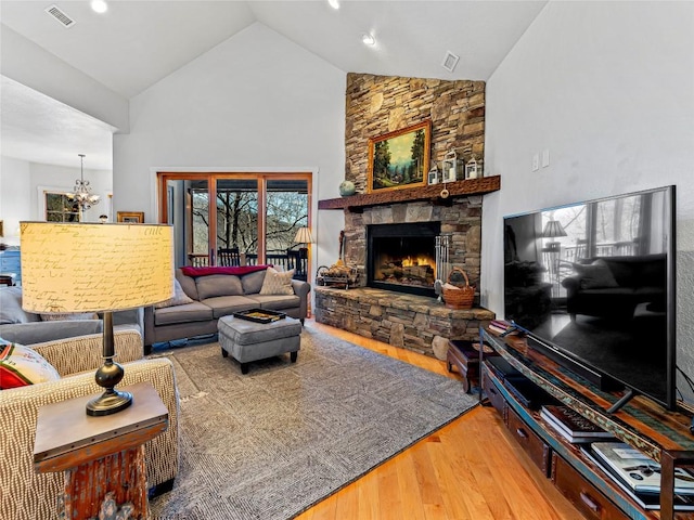 130 Cross Vine Dr, Tuckasegee, NC 28783 - living area with high vaulted ceiling, a notable chandelier, a fireplace, wood finished floors, and visible vents