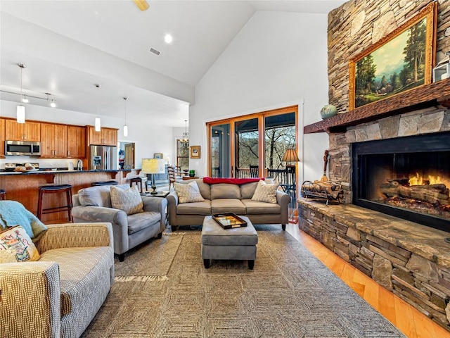 130 Cross Vine Dr, Tuckasegee, NC 28783 - living area featuring high vaulted ceiling, a fireplace, visible vents, and wood finished floors