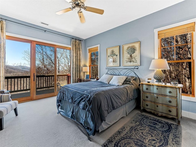 130 Cross Vine Dr, Tuckasegee, NC 28783 - carpeted bedroom featuring access to exterior, baseboards, visible vents, and a ceiling fan
