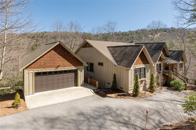 1034 E Rochester Dr, Cashiers, NC 28717 - view of front facade with driveway, roof with shingles, a garage, and board and batten siding