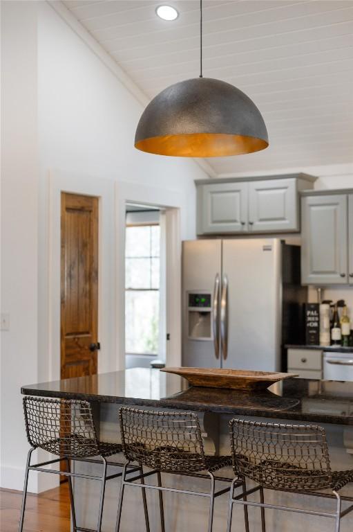 1034 E Rochester Dr, Cashiers, NC 28717 - kitchen with fridge with ice dispenser, a kitchen bar, recessed lighting, and wood finished floors