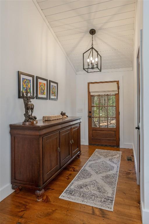 1034 E Rochester Dr, Cashiers, NC 28717 - foyer with a chandelier, dark wood-type flooring, and ornamental molding