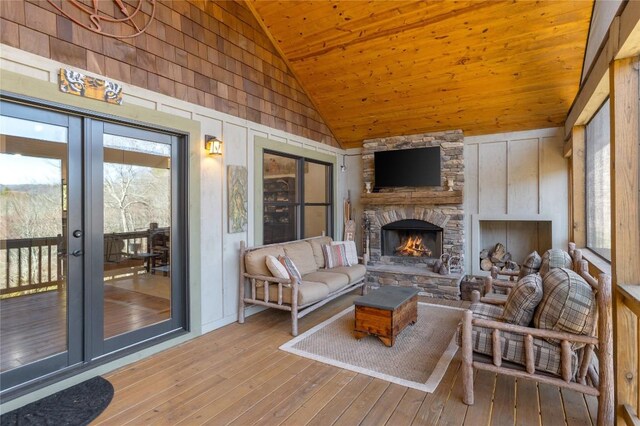 1034 E Rochester Dr, Cashiers, NC 28717 - living area with high vaulted ceiling, wood ceiling, hardwood / wood-style floors, a fireplace, and wooden walls