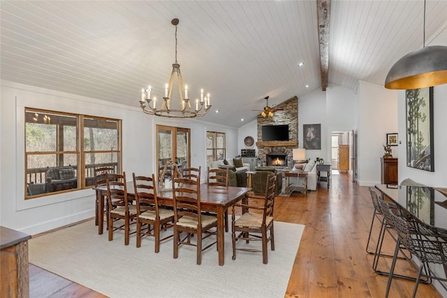 1034 E Rochester Dr, Cashiers, NC 28717 - dining space with a chandelier, wood-type flooring, a stone fireplace, wooden ceiling, and baseboards