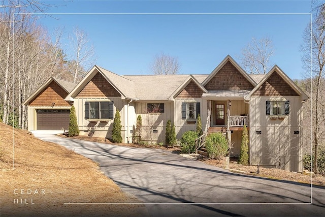 1034 E Rochester Dr, Cashiers, NC 28717 - view of front facade featuring board and batten siding, driveway, a garage, and covered porch