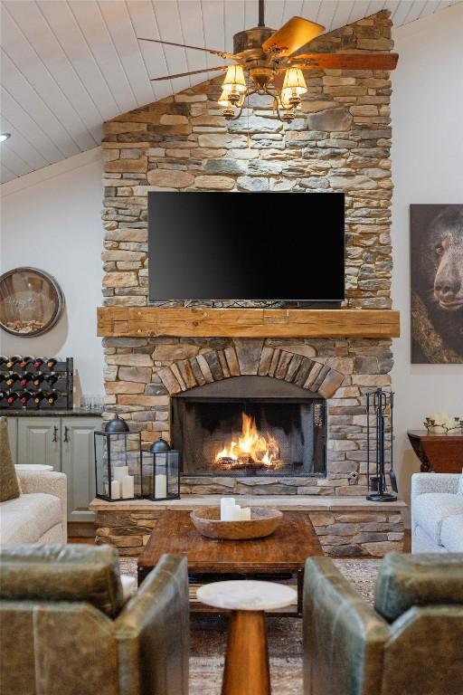 1034 E Rochester Dr, Cashiers, NC 28717 - living area with lofted ceiling, wooden ceiling, and a stone fireplace