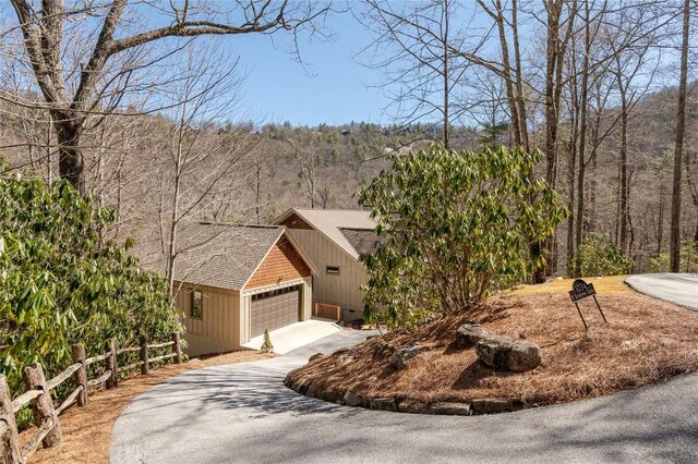 1034 E Rochester Dr, Cashiers, NC 28717 - view of front of property featuring driveway, a garage, and a shingled roof