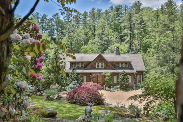 131 Big Creek Ln, Highlands, NC 28741 - view of front of house featuring a chimney and a wooded view