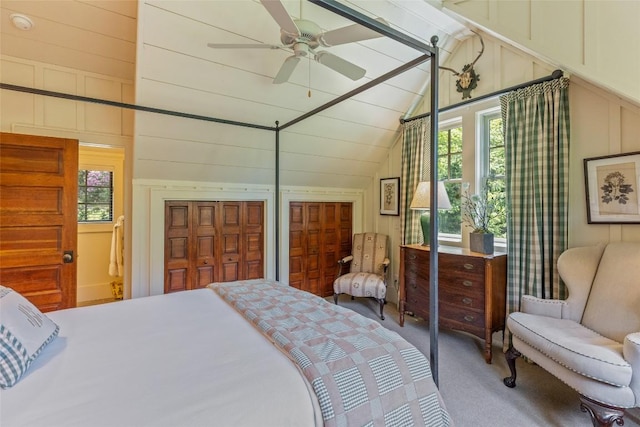 131 Big Creek Ln, Highlands, NC 28741 - carpeted bedroom with vaulted ceiling, multiple windows, ceiling fan, and a decorative wall