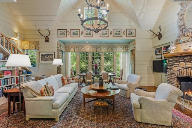 131 Big Creek Ln, Highlands, NC 28741 - living area featuring vaulted ceiling, wooden walls, wood finished floors, a chandelier, and a fireplace