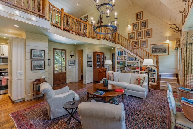 131 Big Creek Ln, Highlands, NC 28741 - living room featuring high vaulted ceiling, wood finished floors, a chandelier, wooden ceiling, and wooden walls
