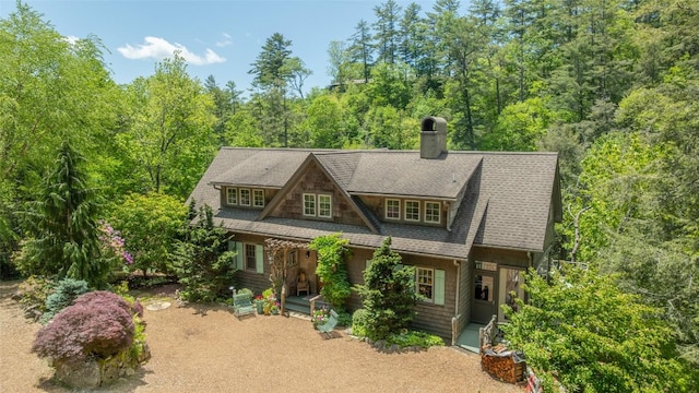 131 Big Creek Ln, Highlands, NC 28741 - view of front of home with a chimney, roof with shingles, and a view of trees