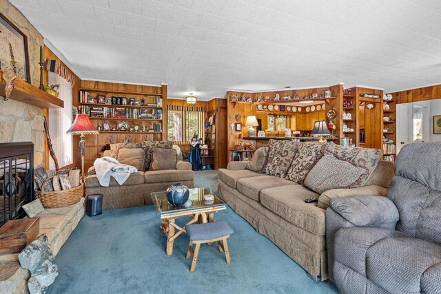 carpeted living room featuring wooden walls and built in shelves