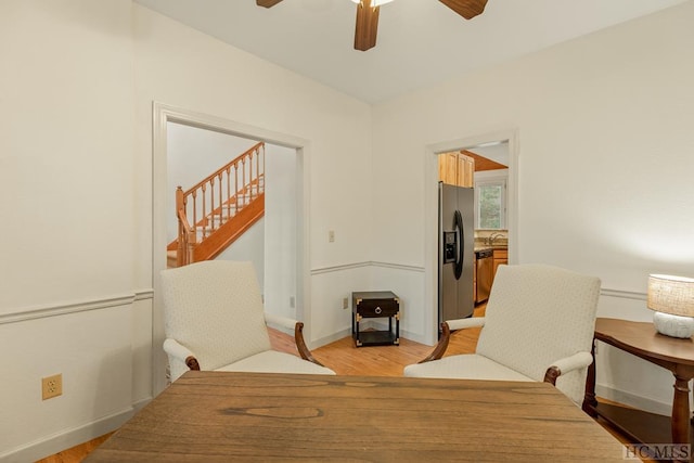 living area featuring ceiling fan, light hardwood / wood-style flooring, and sink