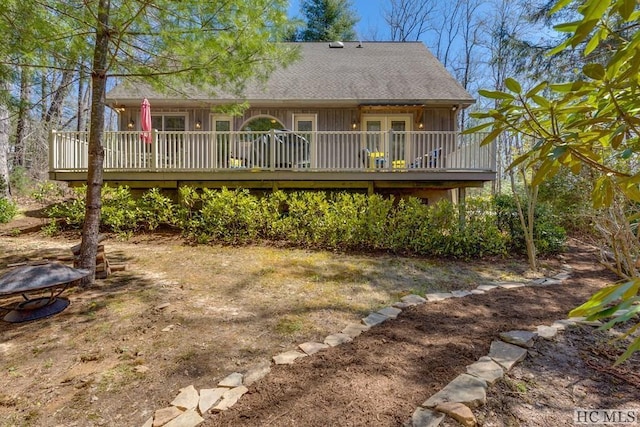 rear view of property with a deck and french doors