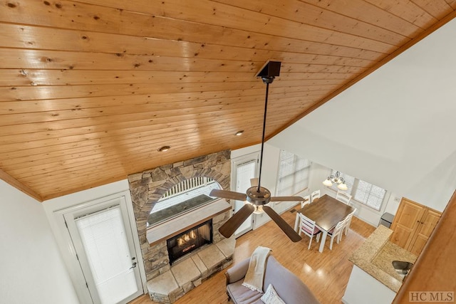 living room with wood ceiling, lofted ceiling, a fireplace, and hardwood / wood-style flooring