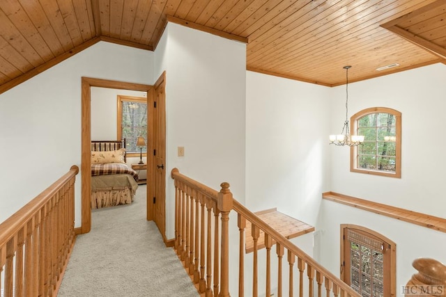 hall with crown molding, wood ceiling, vaulted ceiling, light colored carpet, and a chandelier