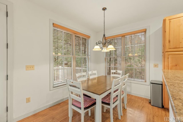 dining area with a chandelier and light hardwood / wood-style floors