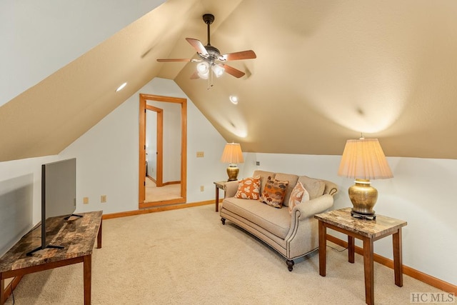 interior space with vaulted ceiling, carpet floors, and ceiling fan