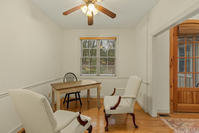 living area featuring ceiling fan and light wood-type flooring