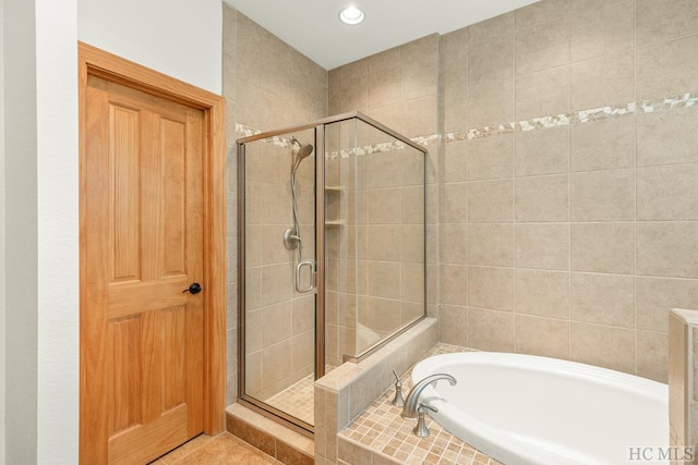 bathroom featuring independent shower and bath and tile patterned flooring