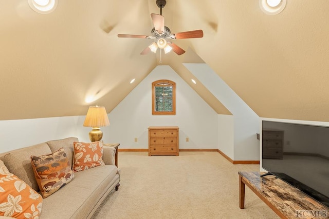 living room with ceiling fan, light colored carpet, and lofted ceiling