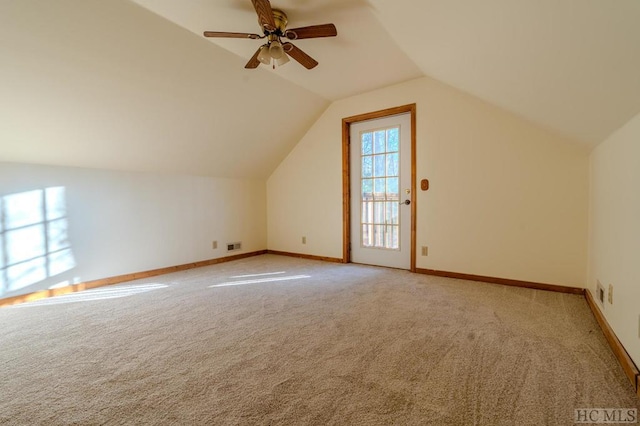 additional living space with light carpet, vaulted ceiling, and ceiling fan