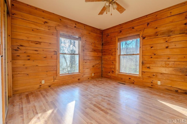 unfurnished room with ceiling fan and light wood-type flooring