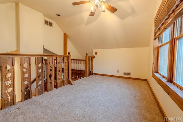 bonus room with lofted ceiling, light colored carpet, and ceiling fan