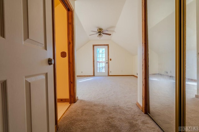 additional living space with light carpet, vaulted ceiling, and ceiling fan