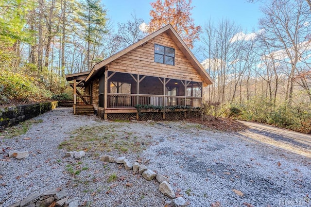 log cabin featuring a sunroom