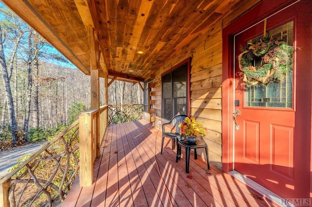 wooden terrace featuring covered porch