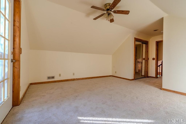 bonus room featuring lofted ceiling, light carpet, and ceiling fan