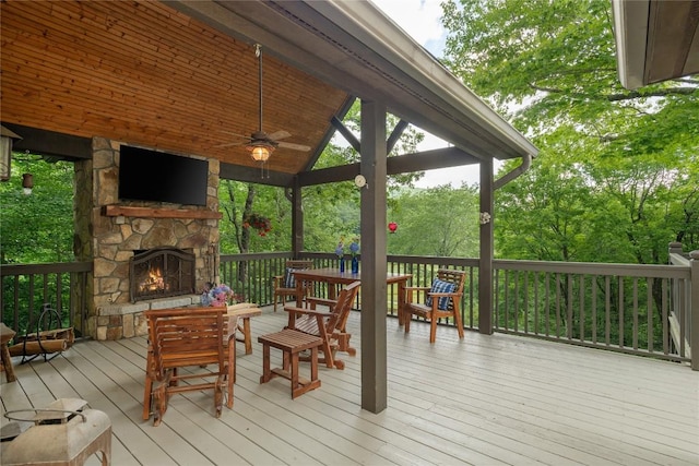 614 Fairway Dr, Lake Toxaway, NC 28747 - deck featuring an outdoor stone fireplace and ceiling fan