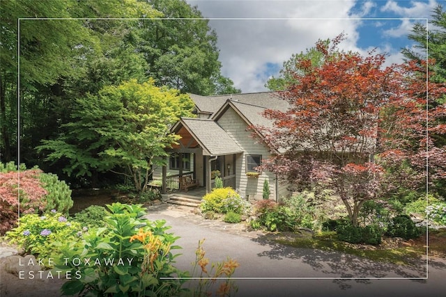614 Fairway Dr, Lake Toxaway, NC 28747 - obstructed view of property featuring a porch and a shingled roof