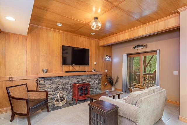 614 Fairway Dr, Lake Toxaway, NC 28747 - tiled living area featuring a wood stove, wood walls, wooden ceiling, and recessed lighting