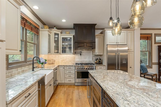 614 Fairway Dr, Lake Toxaway, NC 28747 - kitchen featuring built in appliances, crown molding, light stone counters, glass insert cabinets, and plenty of natural light