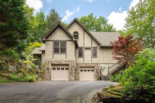 614 Fairway Dr, Lake Toxaway, NC 28747 - view of front of property with stairway, stone siding, driveway, an attached garage, and a shingled roof
