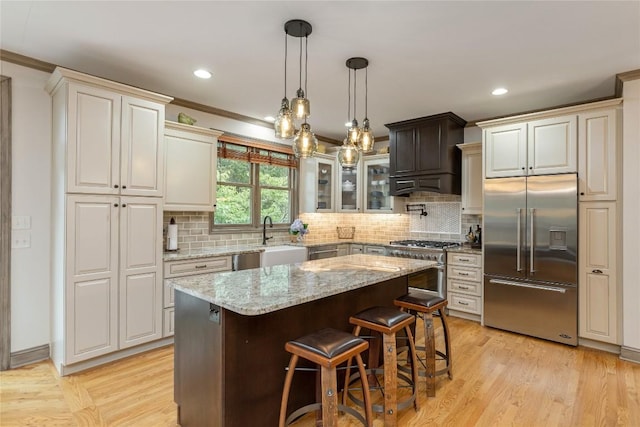614 Fairway Dr, Lake Toxaway, NC 28747 - kitchen with high quality appliances, light stone countertops, backsplash, a breakfast bar area, and a kitchen island