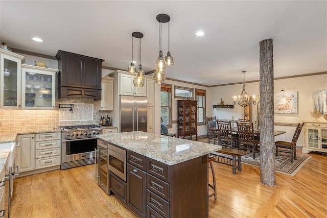 614 Fairway Dr, Lake Toxaway, NC 28747 - kitchen with built in appliances, ornamental molding, custom exhaust hood, light wood-style flooring, and decorative backsplash