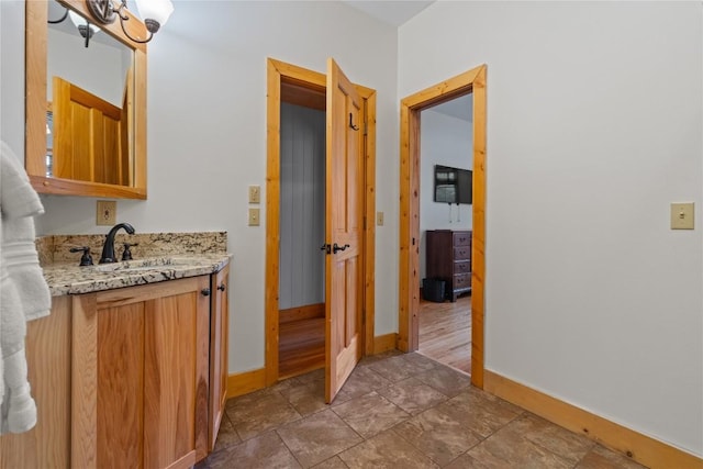 56 First Tee Trl B/Upper, B/Upper Cashiers, NC 28717 - bathroom featuring baseboards, vanity, and stone finish floors