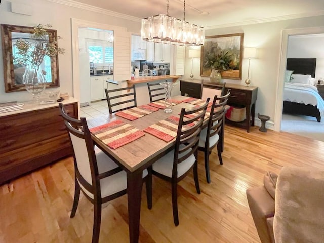 704 Highlands Mountain Club Rd Unit 704, Highlands, NC 28741 - dining space featuring ornamental molding, light wood-type flooring, and a chandelier