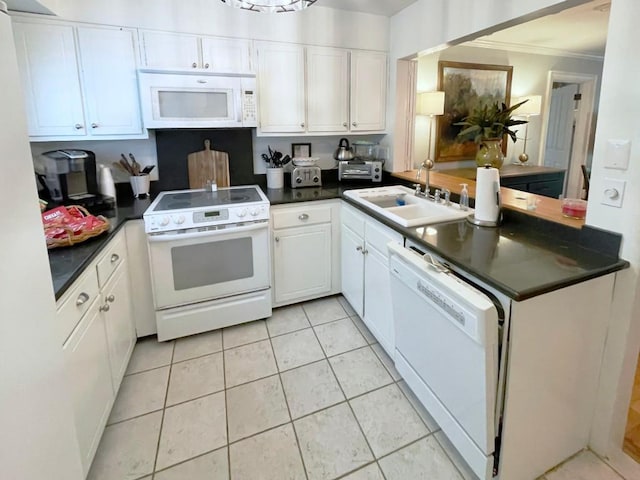 704 Highlands Mountain Club Rd Unit 704, Highlands, NC 28741 - kitchen with white appliances, dark countertops, ornamental molding, and white cabinets