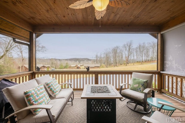 wooden deck featuring an outdoor living space with a fire pit